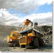 photo of an excavator loading a dumptruck